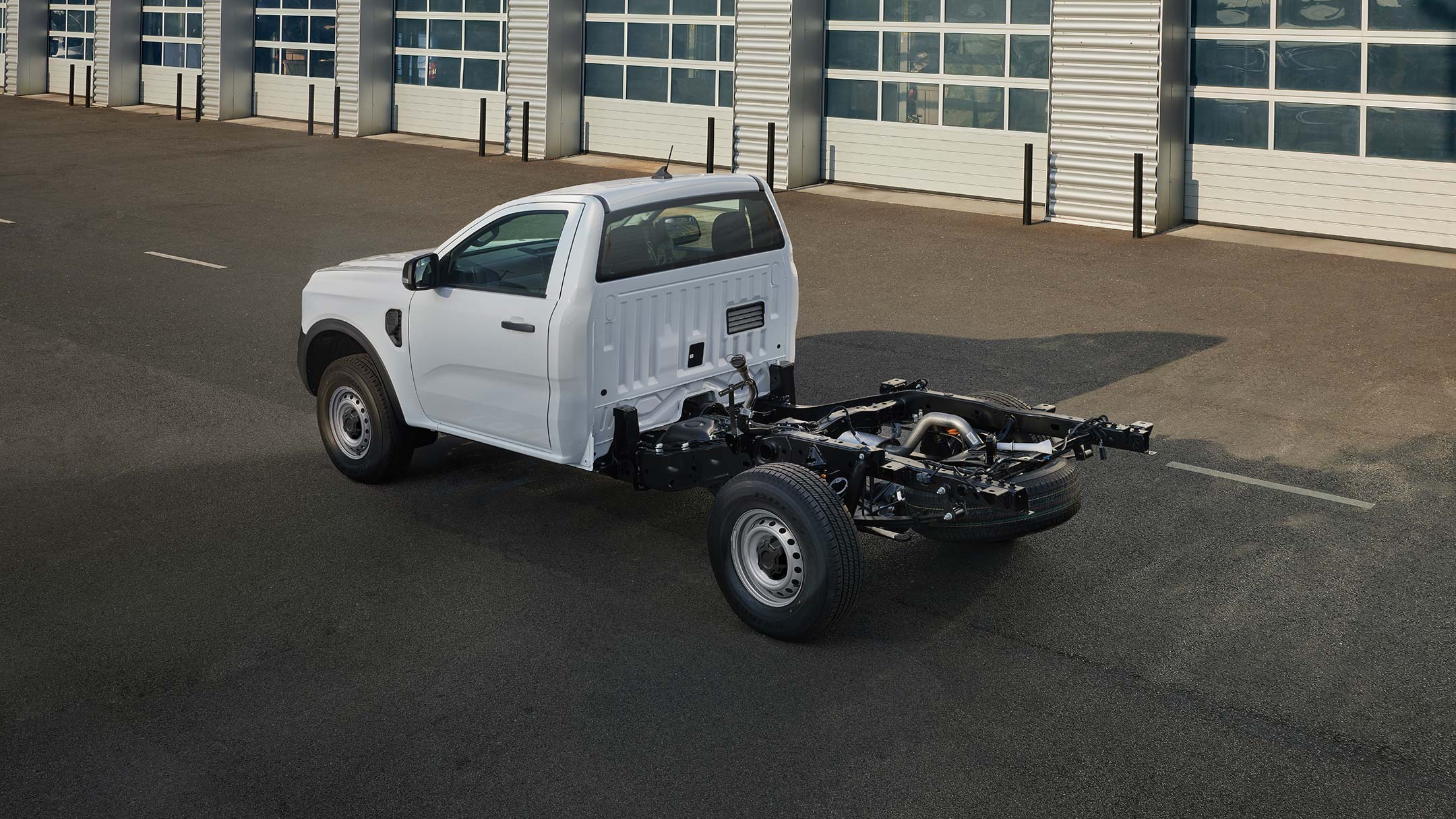 Ford Ranger Chassis Cab next to garages