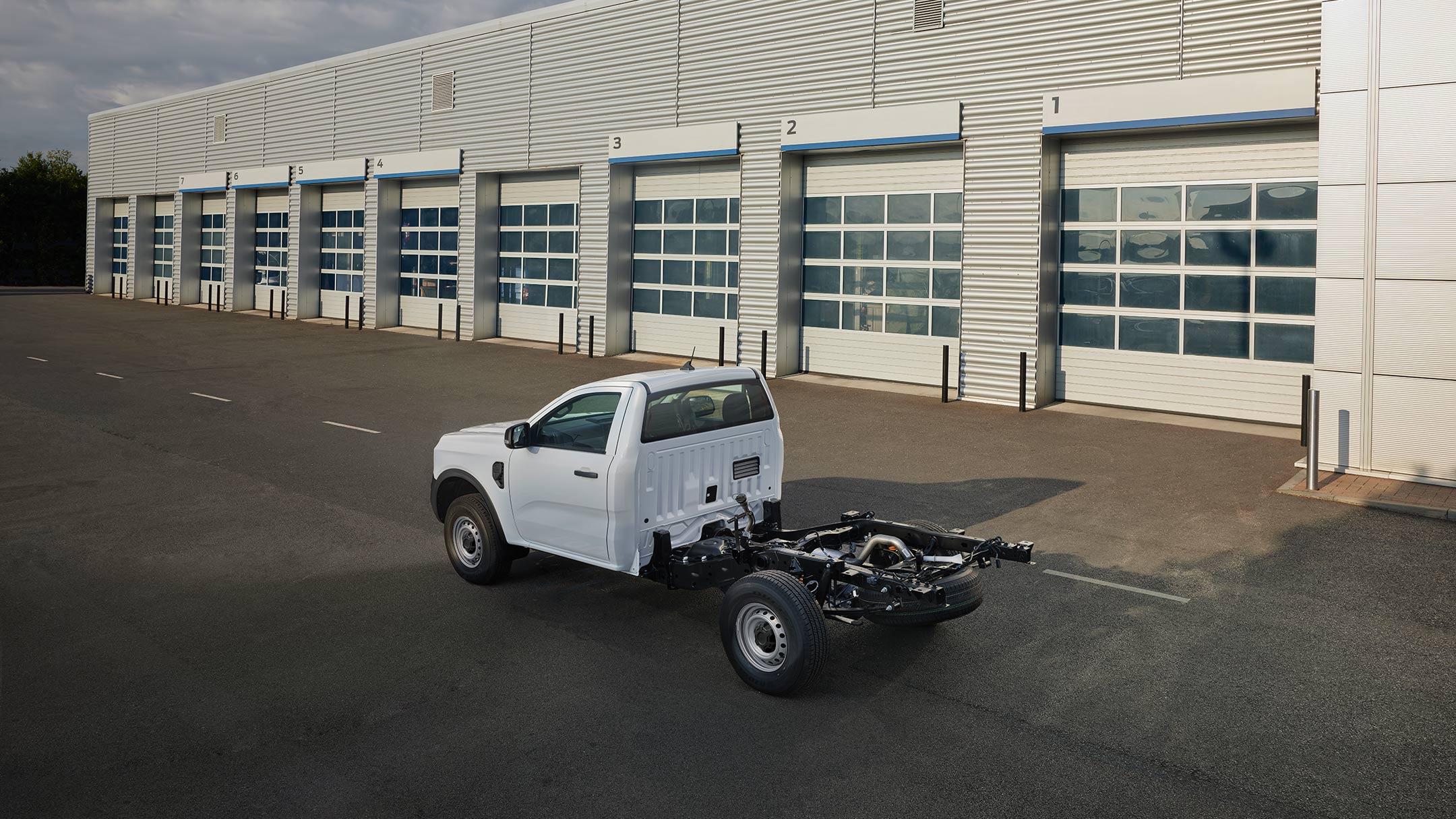 Ford Ranger Chassis Cab next to garages