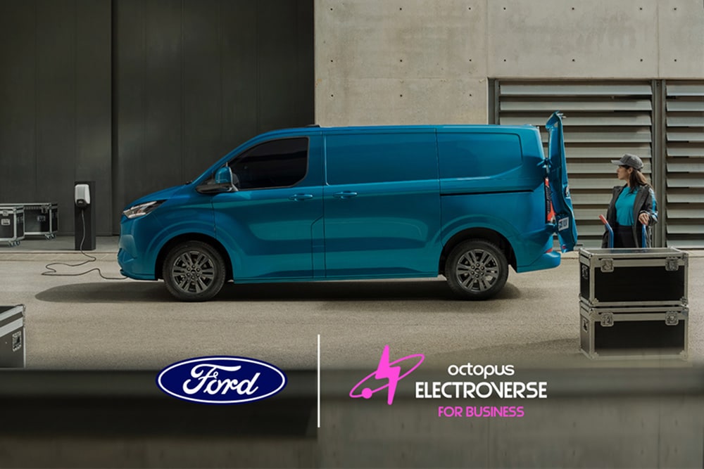 Side view of a Blue Ford E-Transit Custom parked with an open rear door and a person standing nearby.