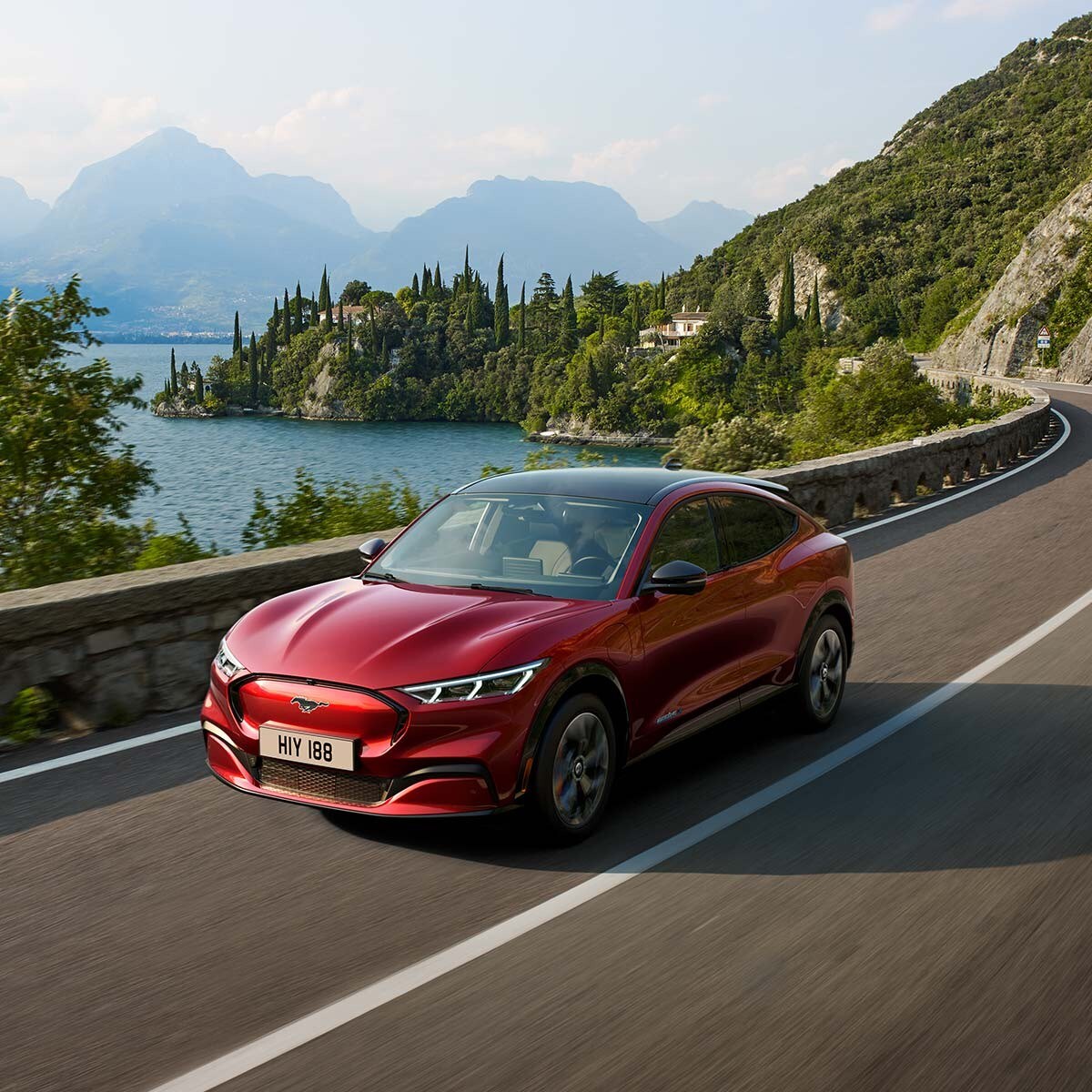 All-New Ford Mustang Mach-E AWD model driving past the lake