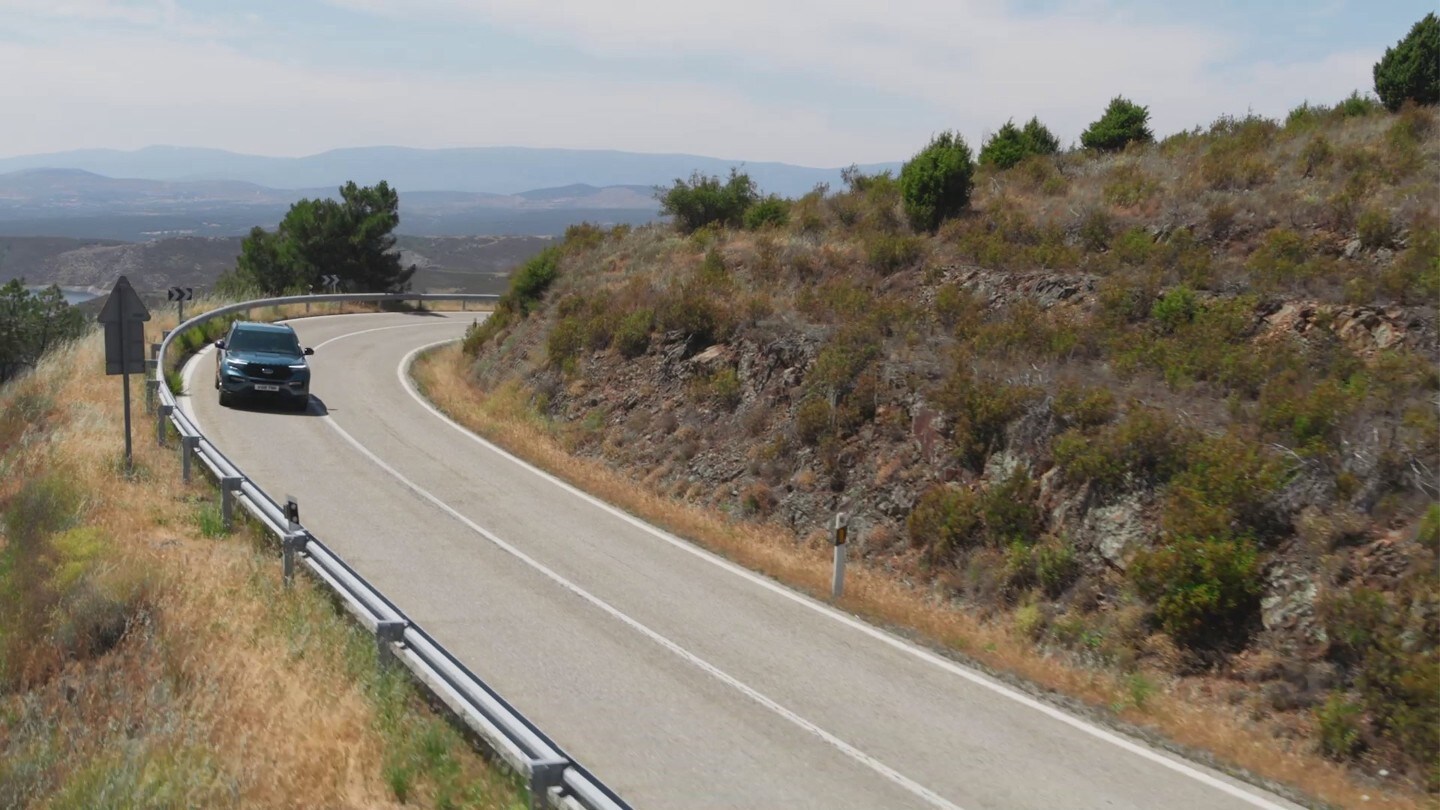 Ford Explorer driving on mountain road