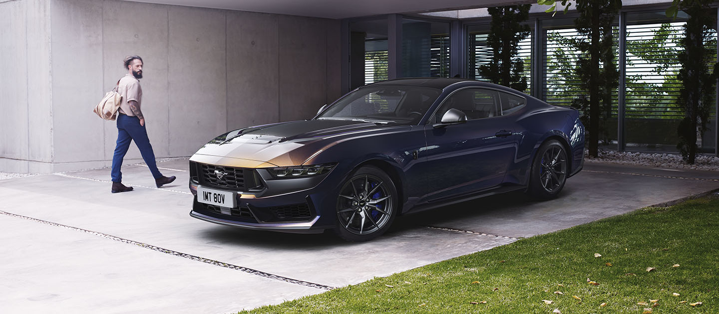 Ford Mustang Dark Horse parked outside a house