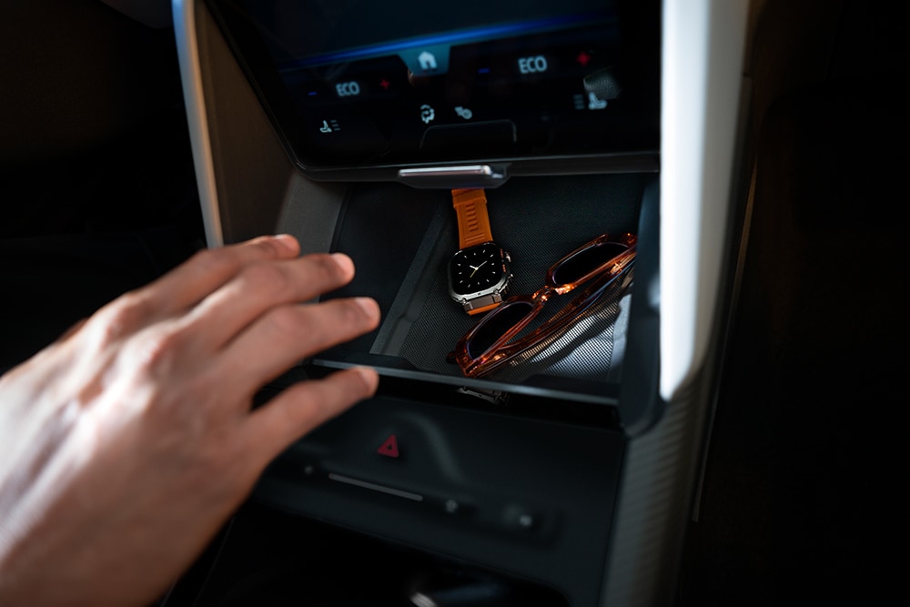 The Ford Capri® My Private Locker storage space holding a watch and sunglasses.
