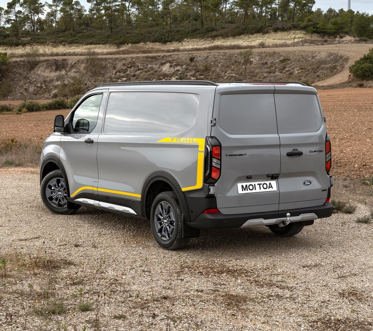 Ford Transit Trail parked on gravel road