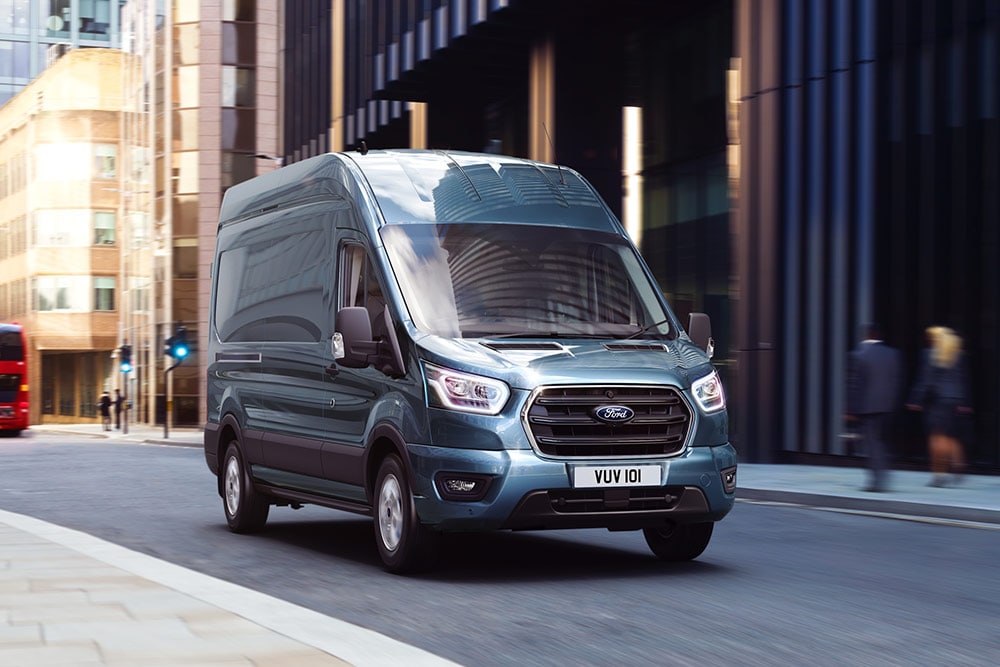 Ford Transit Van jedoucí po městě.