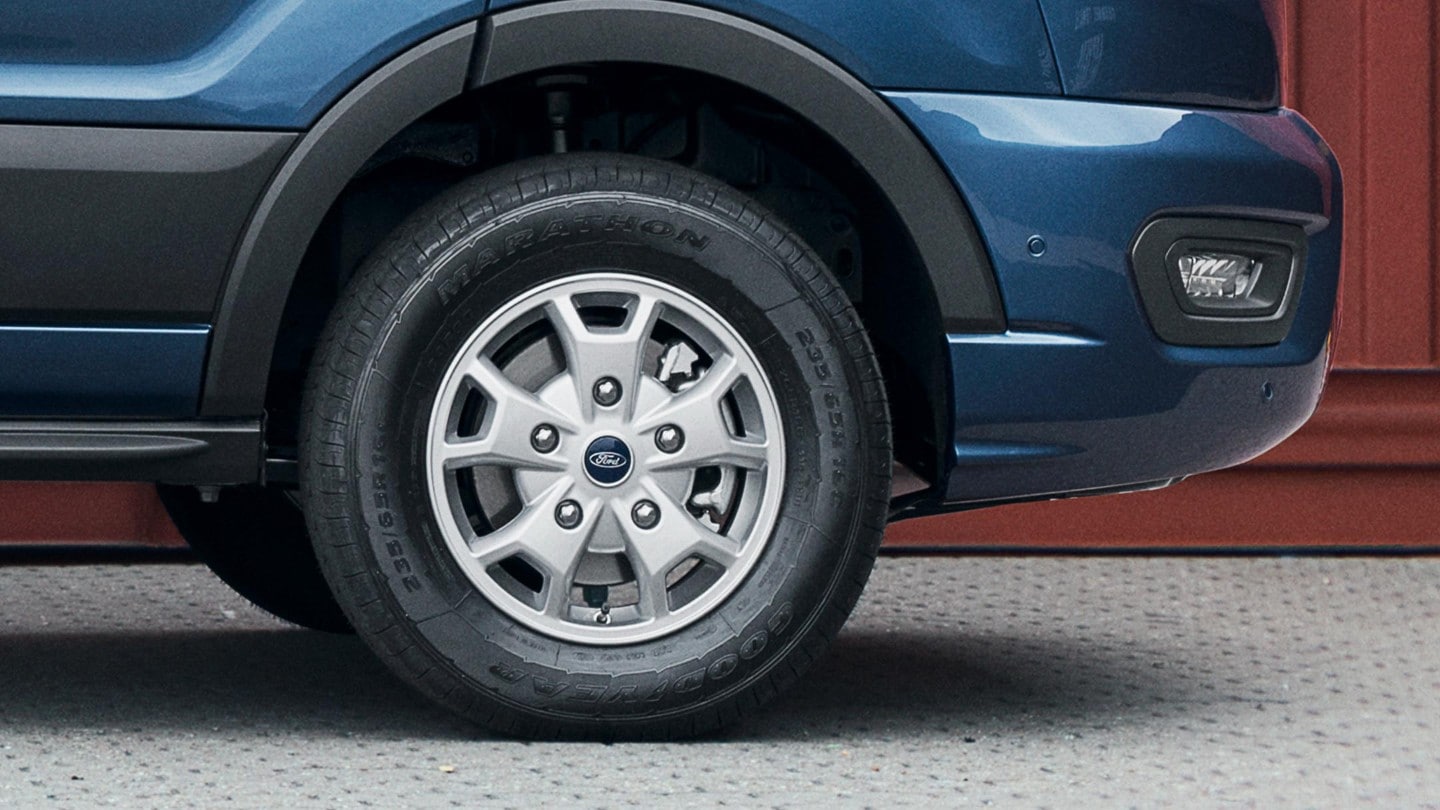 Blue Ford Transit Double Cab's front wheel close up